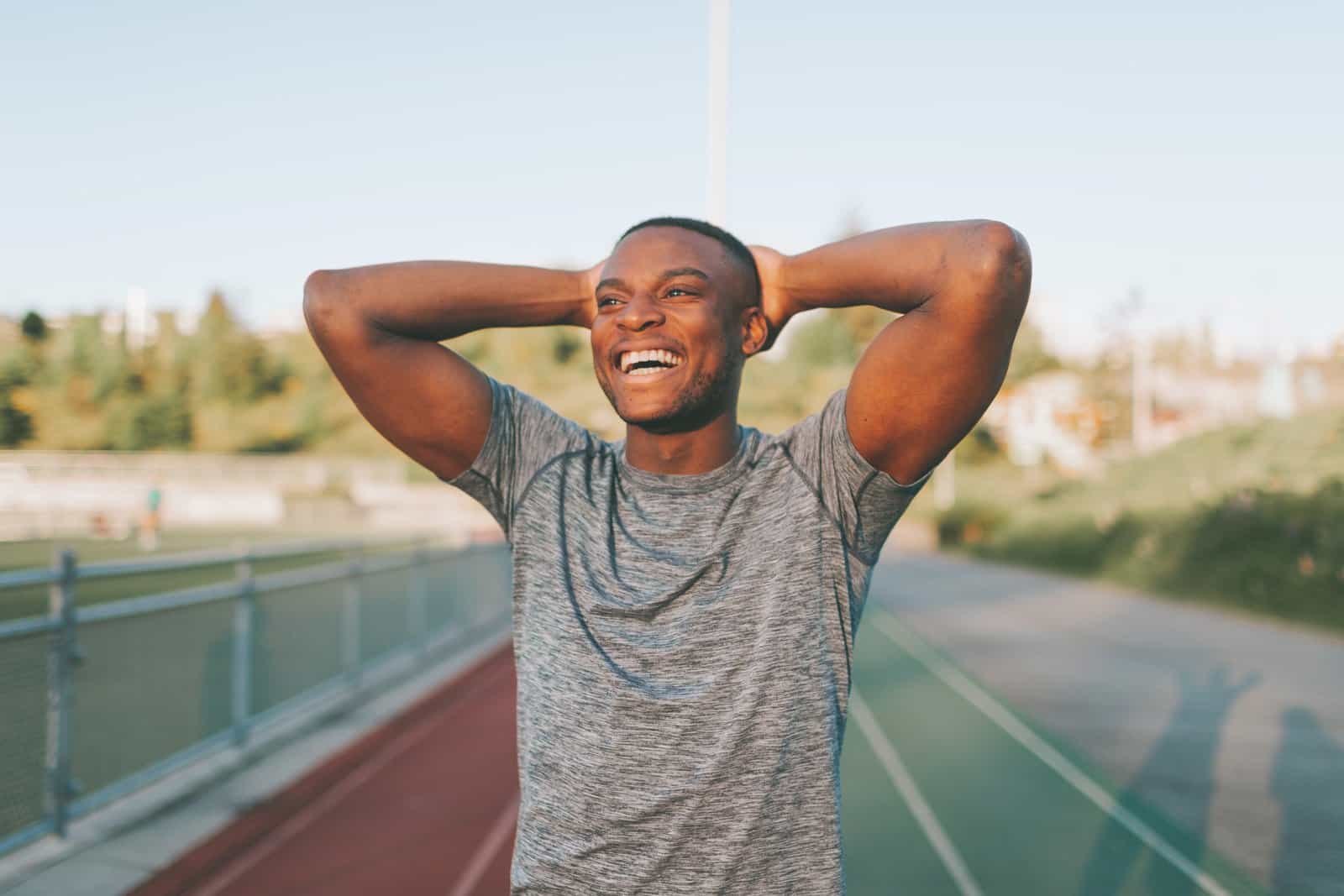 Image of a man smiling after running at a running track